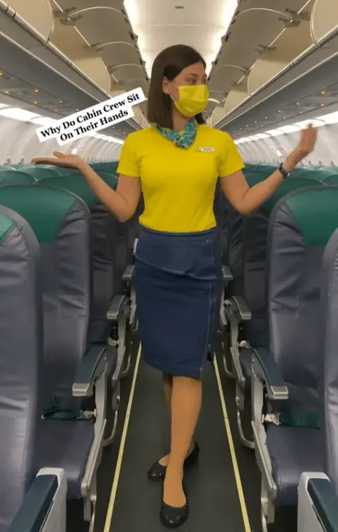 Flight Attendant Unveils Unexpected Reason Cabin Crew Sits on Their Hands During Takeoff and Landing